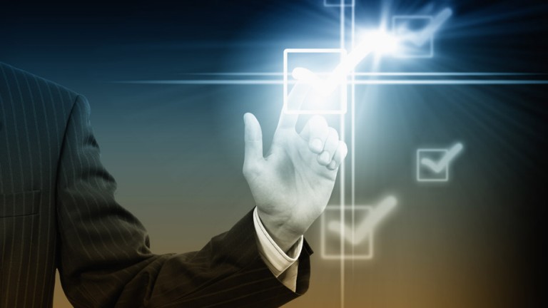 Person in suit touching checkmark on screen