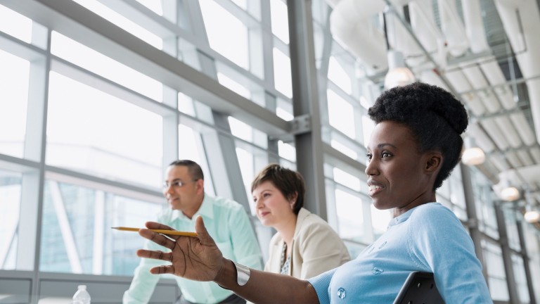 black-businesswoman-talking-colleagues-office-building